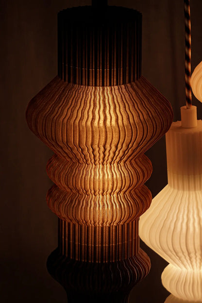 Détail de la texture plissée de la suspension Vira imprimée en 3D en PLA à base de marc de café recyclé. 